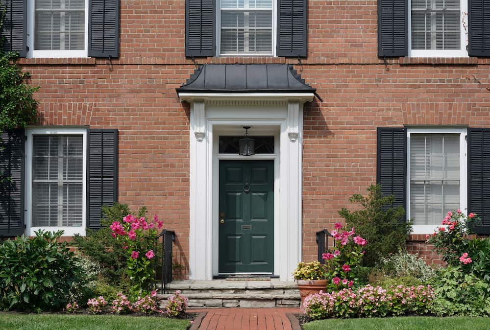 front door of brick two storey house with landscaping