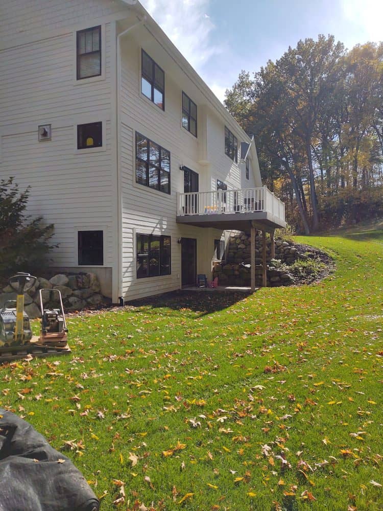 Before photo of project done by Torchwood Landscaping: A New Deck and Patio in Ada, MI. Image shows the back deck and backyard.