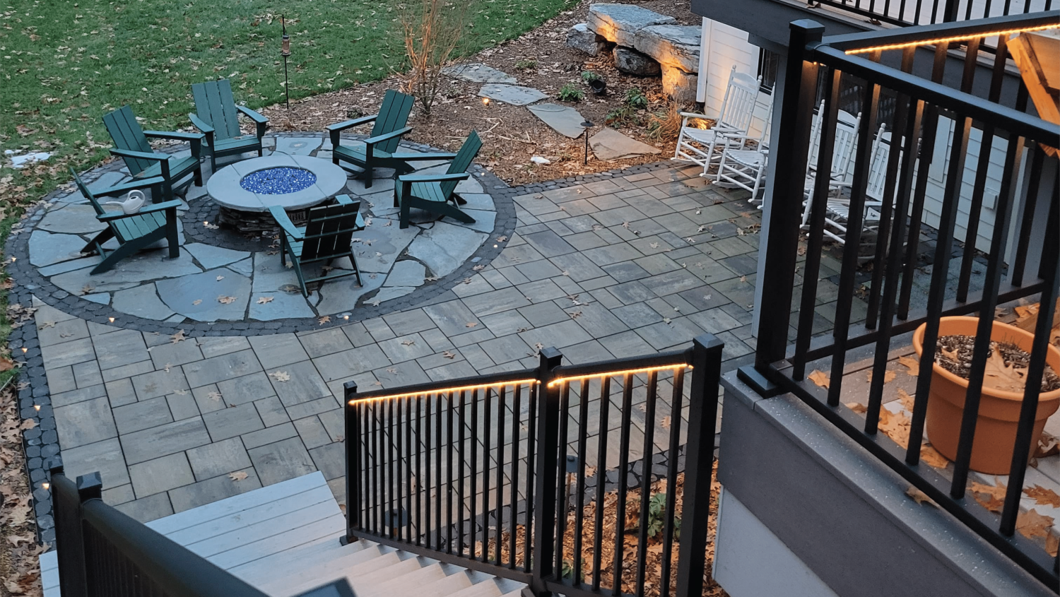 Project done by Torchwood Landscaping: A New Deck and Patio in Ada, MI. Photo is overlooking the new patio in the evening.