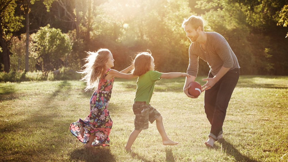 Man playing with his children (4-5) in backyard