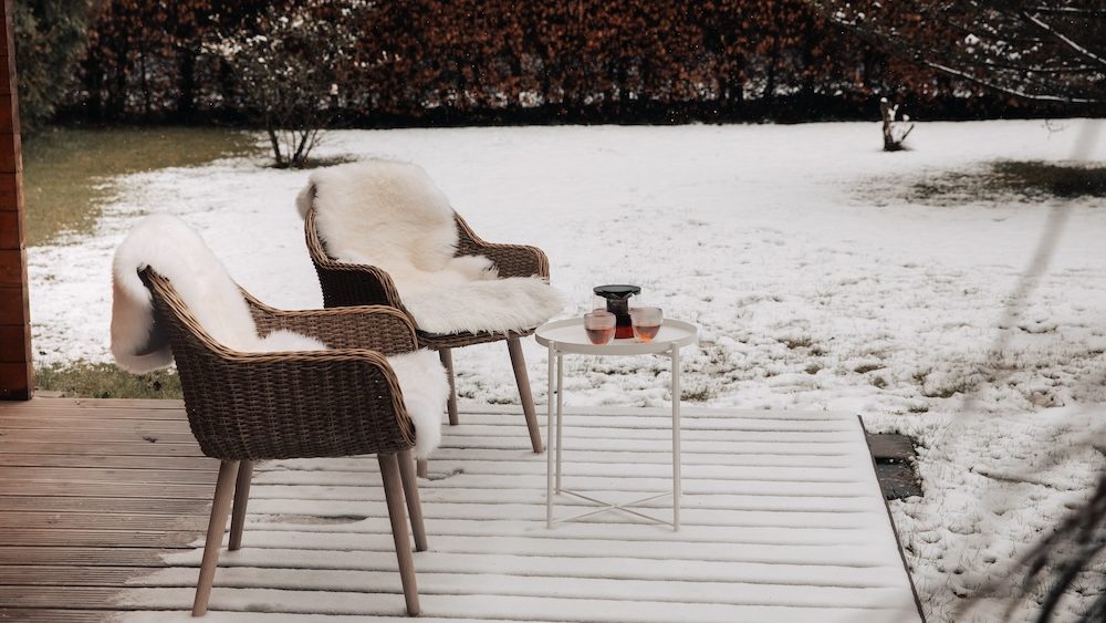 Nice wooden hut in a garden with snow. Garden shed with chairs in winter. Winter mood. Drinking tea outside by cold in winter.  snow in Germany. garden in winter. holiday house