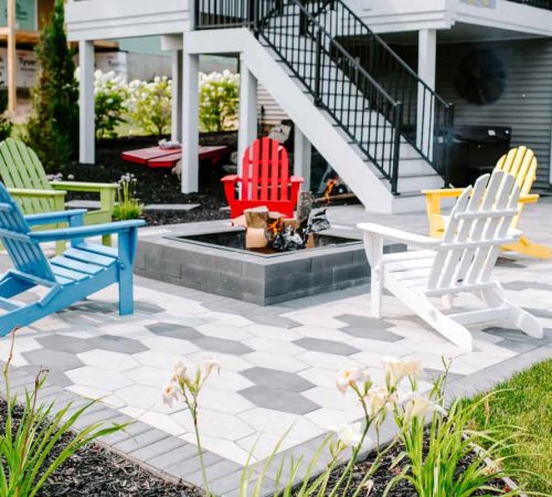 paver patio with firepit and colorful chairs