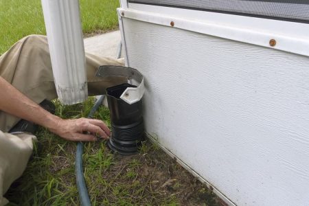 Man Installing Residential Downspout Connectors